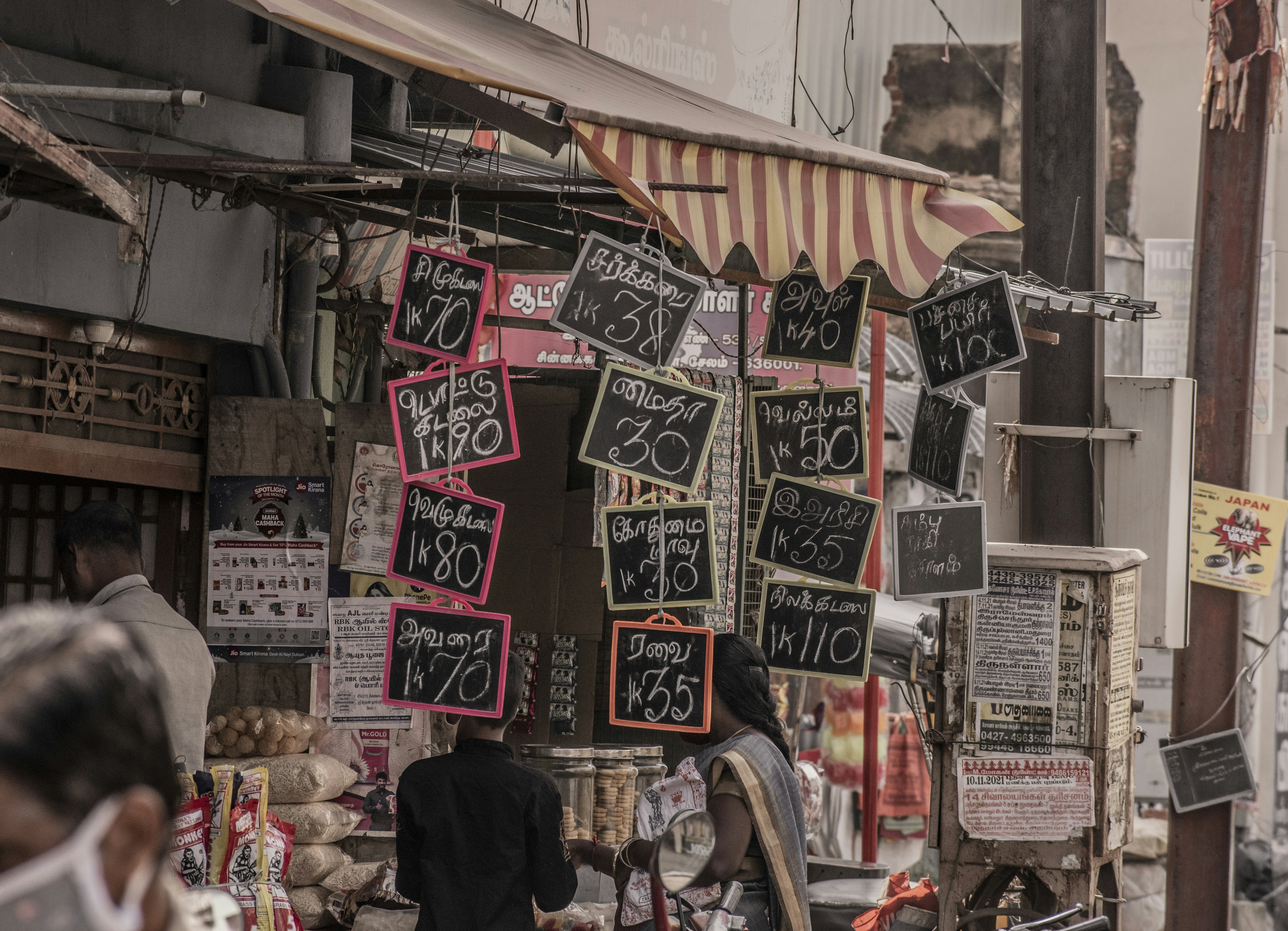 a man walking down a street next to a store