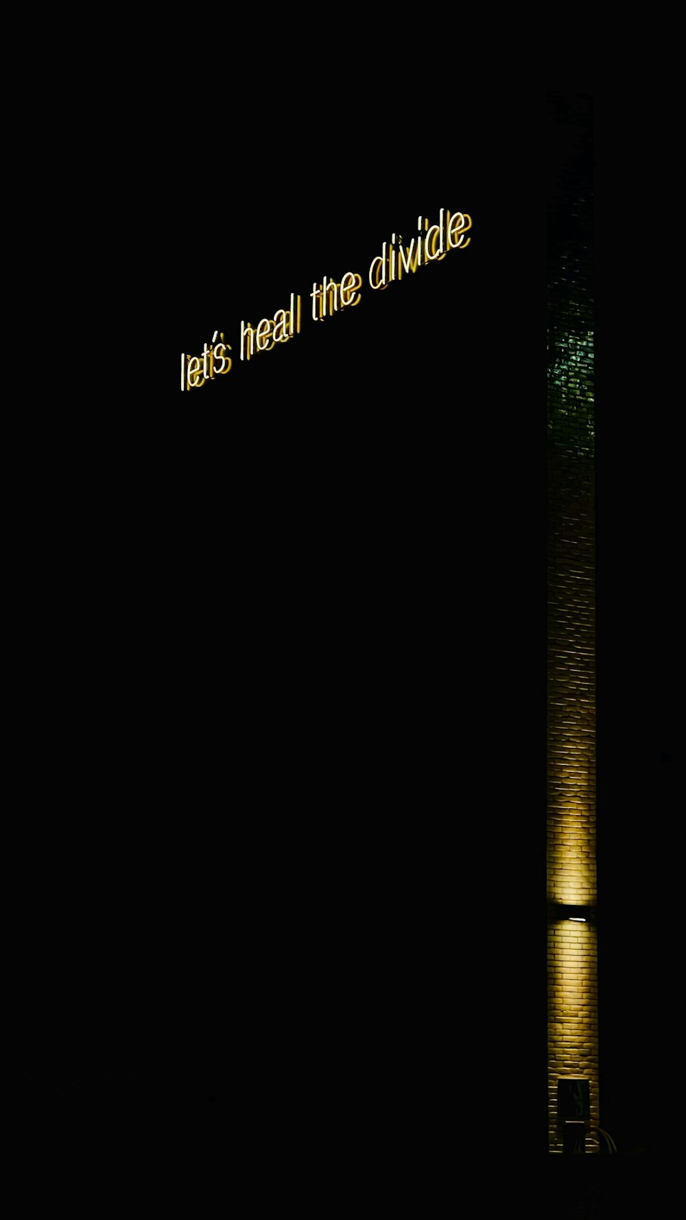 a street sign lit up at night in the dark