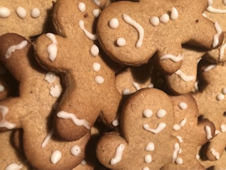 Soft and chewy gingerbread cookies shaped like little men with icing details on a festive plate.