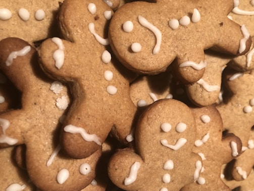 Soft and chewy gingerbread cookies shaped like little men with icing details on a festive plate.