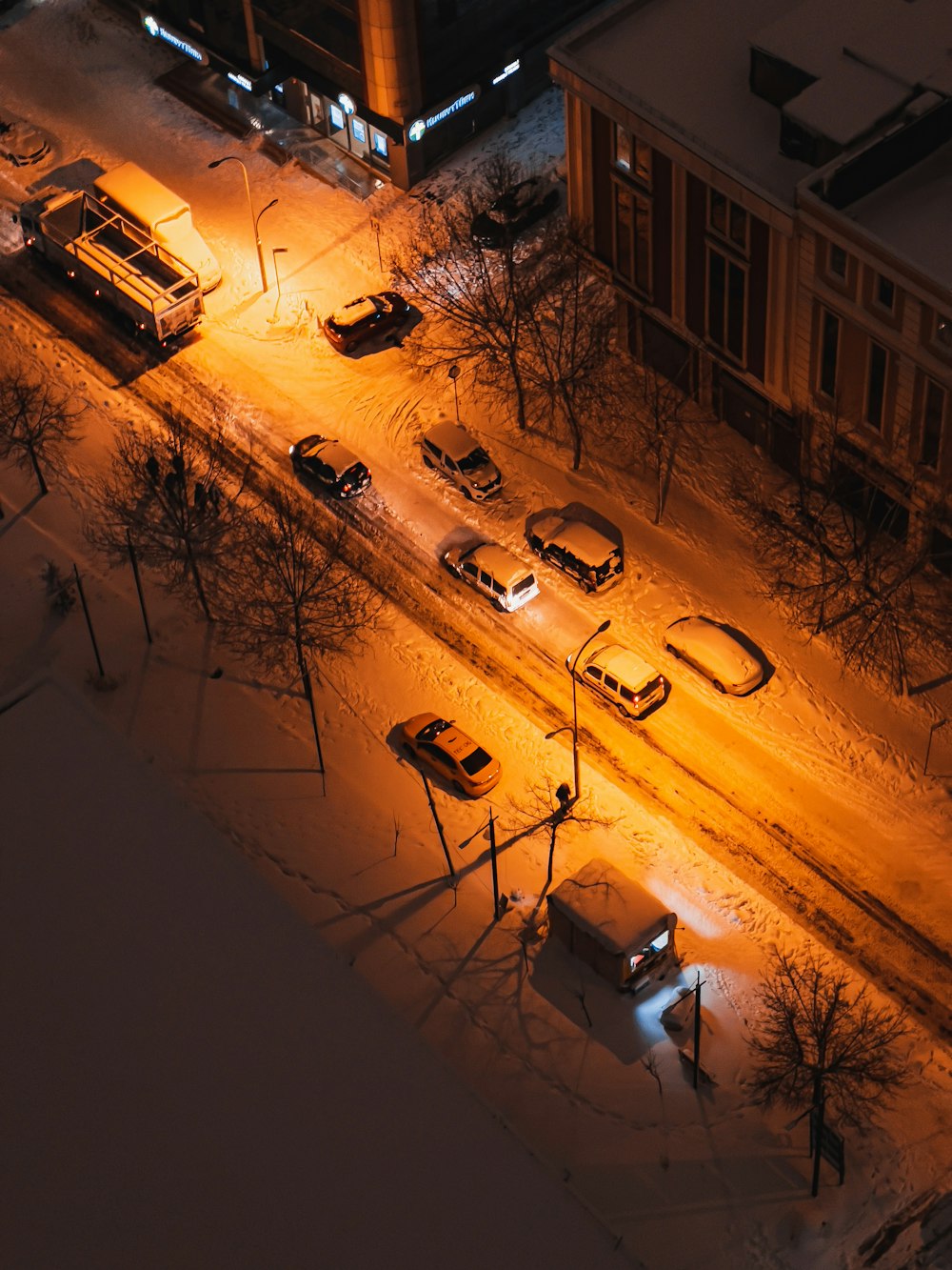 a city street at night covered in snow