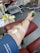 A smiling blood donor giving blood at a donation center.