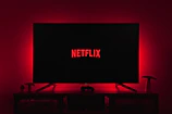 Cozy corner of the studio with a TV screen displaying Netflix interface.
