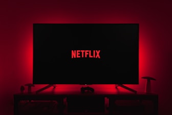 a television with the netflix logo lit up in the dark