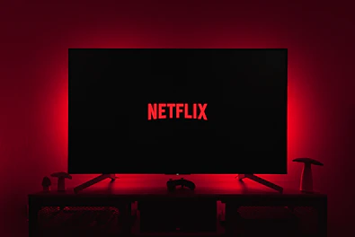 Cozy corner of the studio with a TV screen displaying Netflix interface.