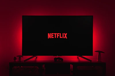 a television with the netflix logo lit up in the dark