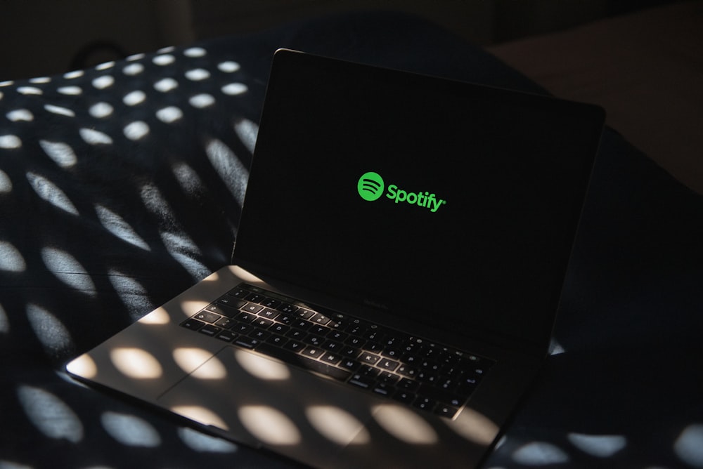 a laptop computer sitting on top of a bed