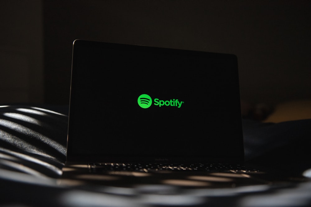 a laptop computer sitting on top of a bed