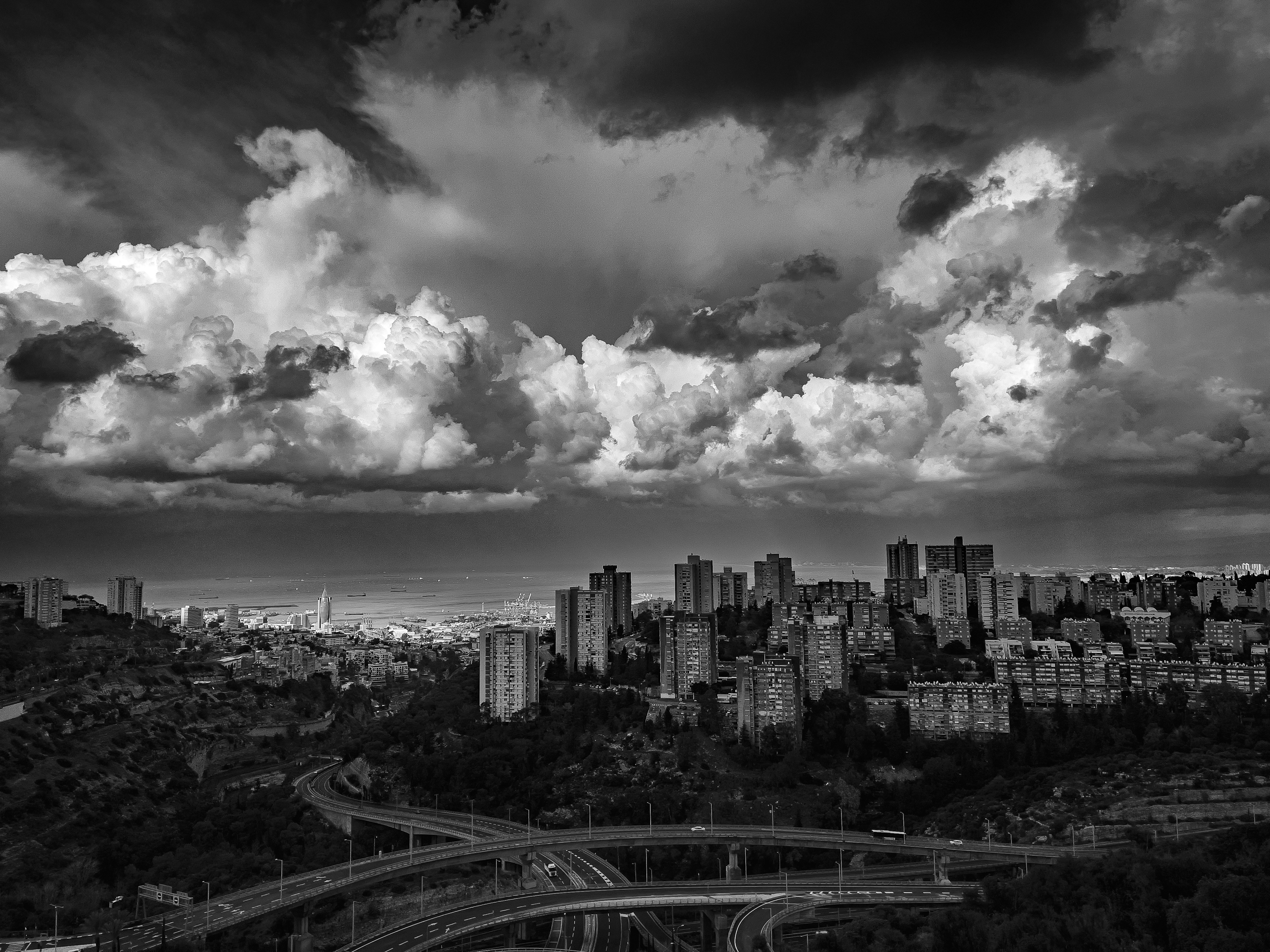 A black and white photo of clouds over a city photo – Free Sky Image on ...
