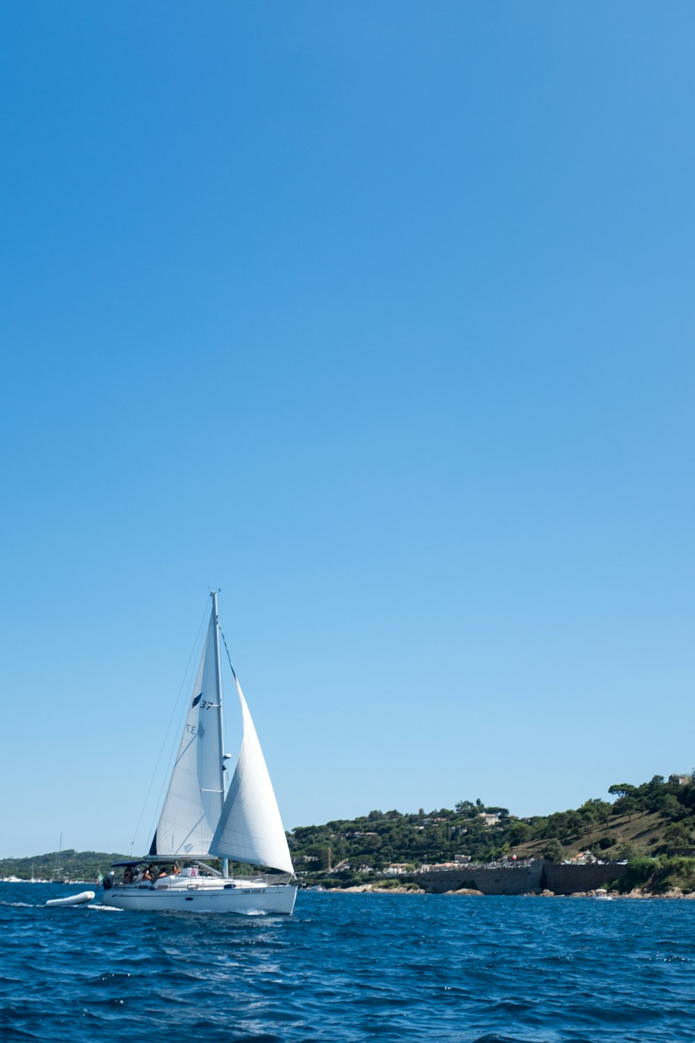 a sailboat sailing on a body of water