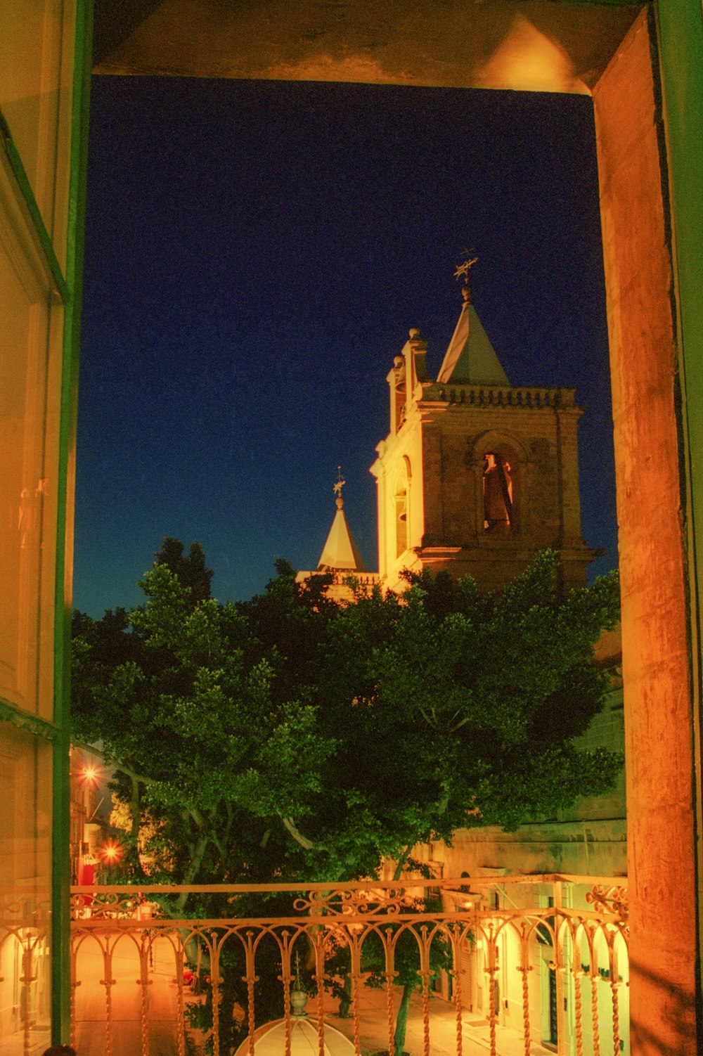 a view of a church from a balcony at night