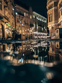 Artistic shot of a historic city street with warm lighting and detailed facades