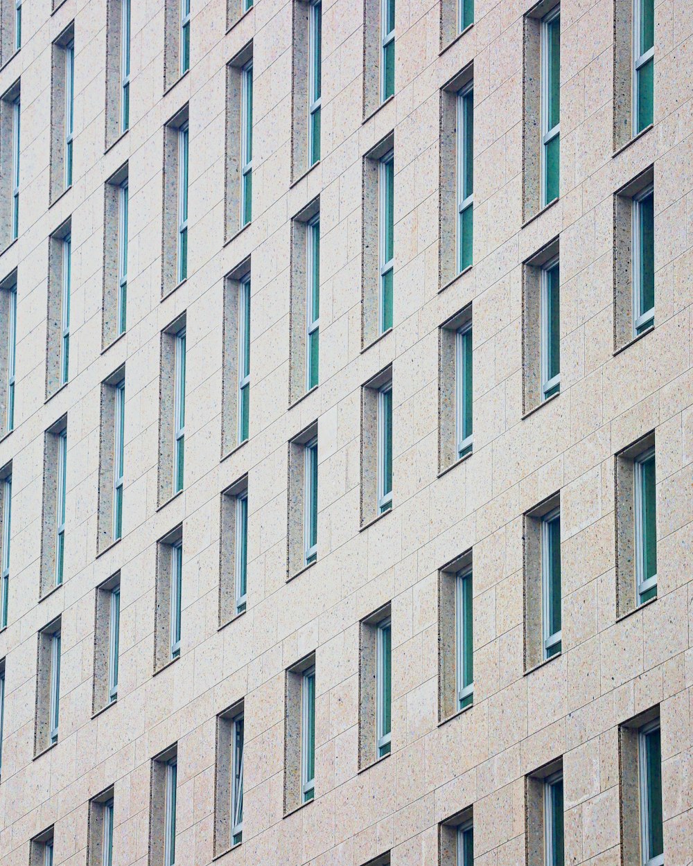 a building with many windows and a clock on the front of it