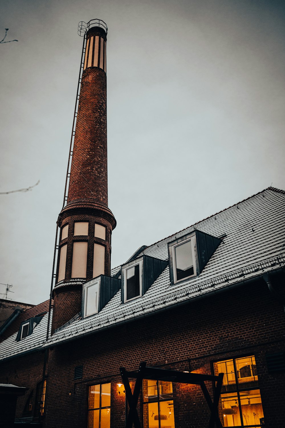 a tall brick building with a clock on it's side