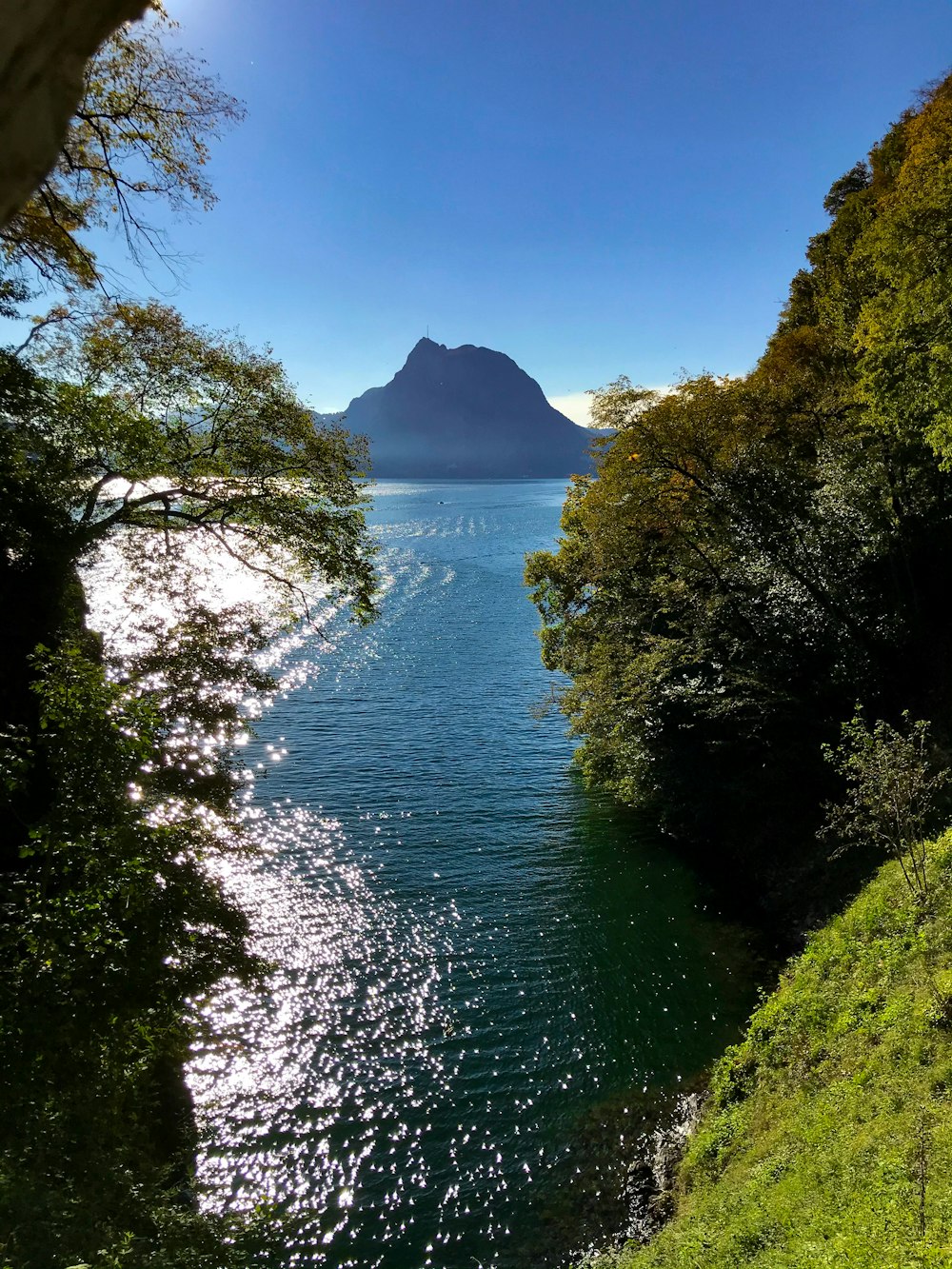 a body of water with a mountain in the background