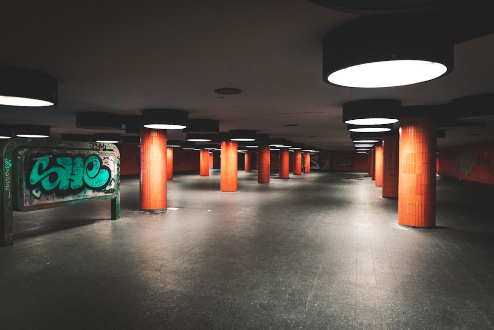 an empty parking garage with graffiti on the walls