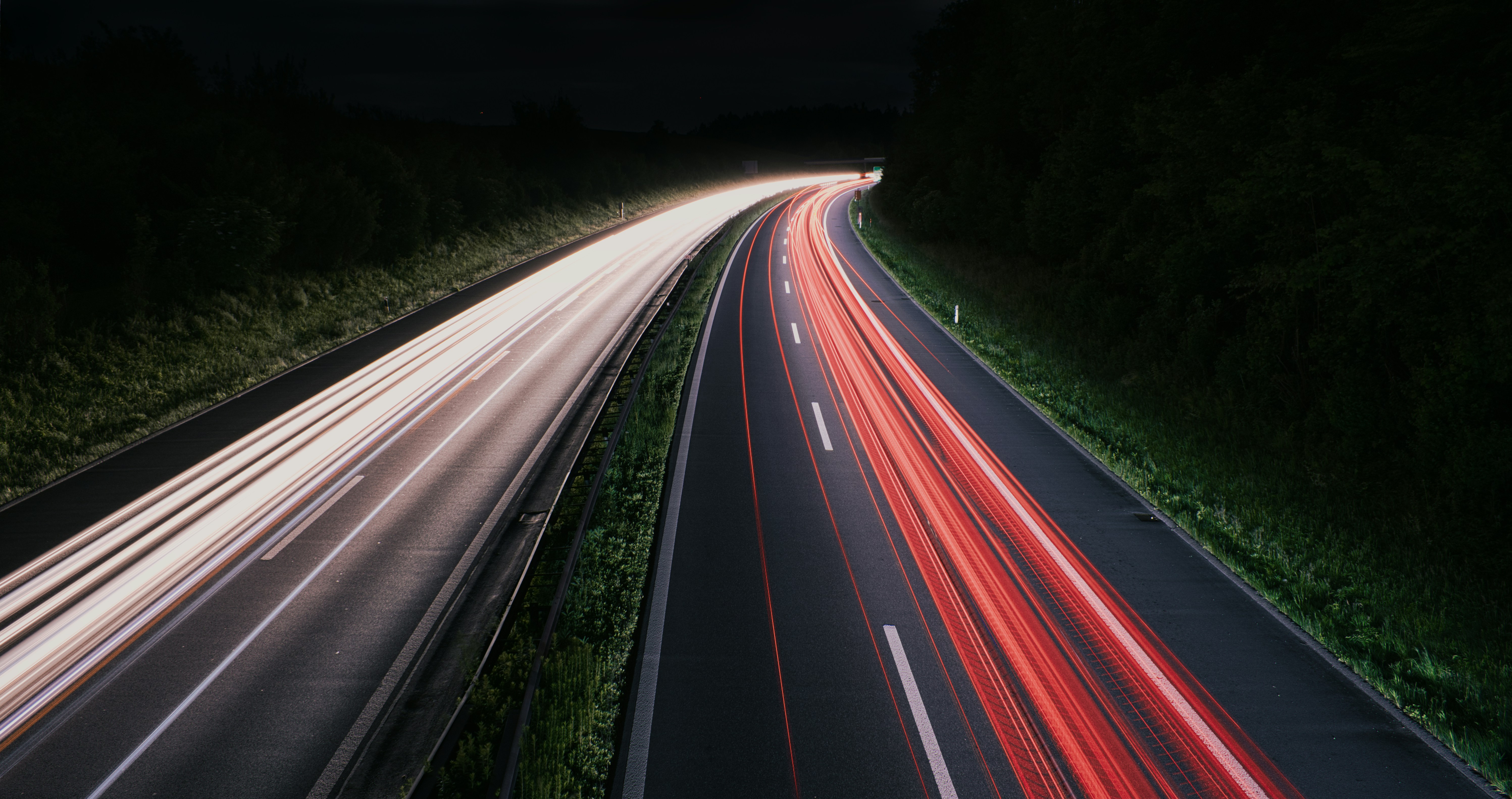 a long exposure photo of a highway at night, Lightrails on a swiss highway