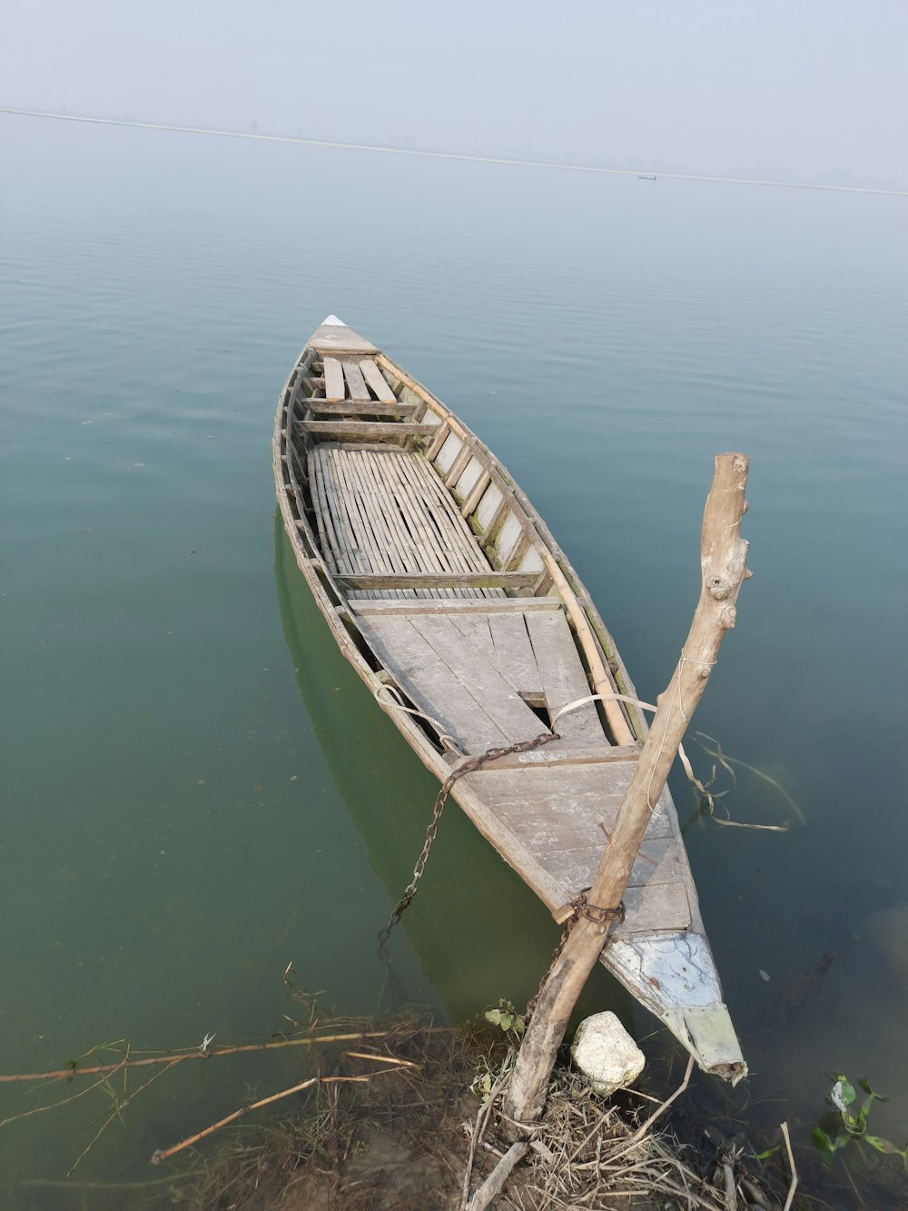 a small boat sitting on top of a body of water