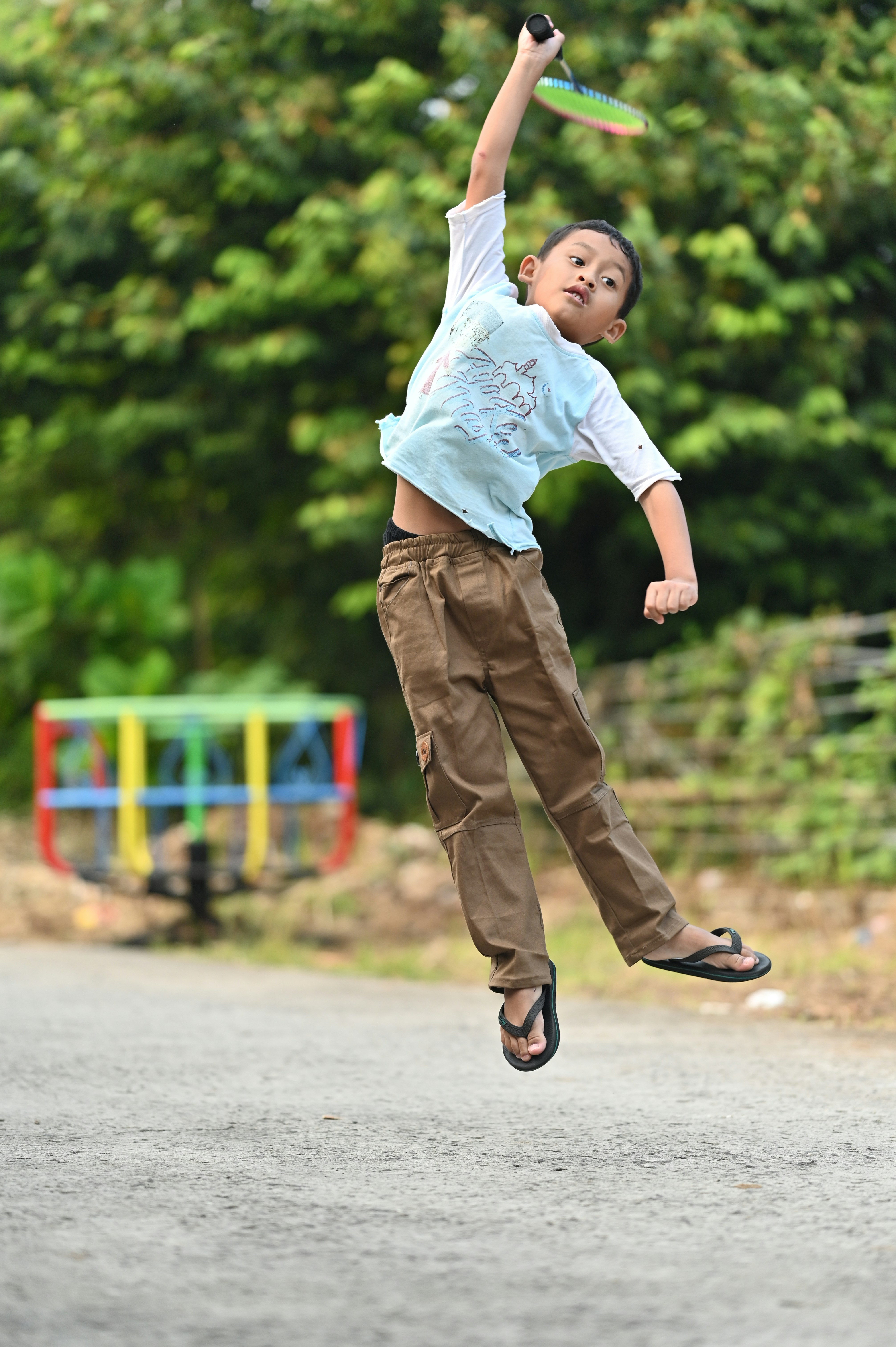 boy flying with badminton racket
