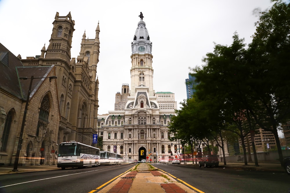 a large building with a clock tower next to a street