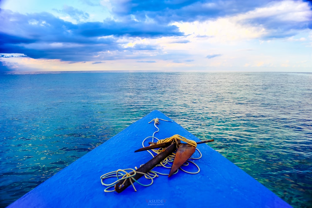 a blue boat in the middle of a body of water