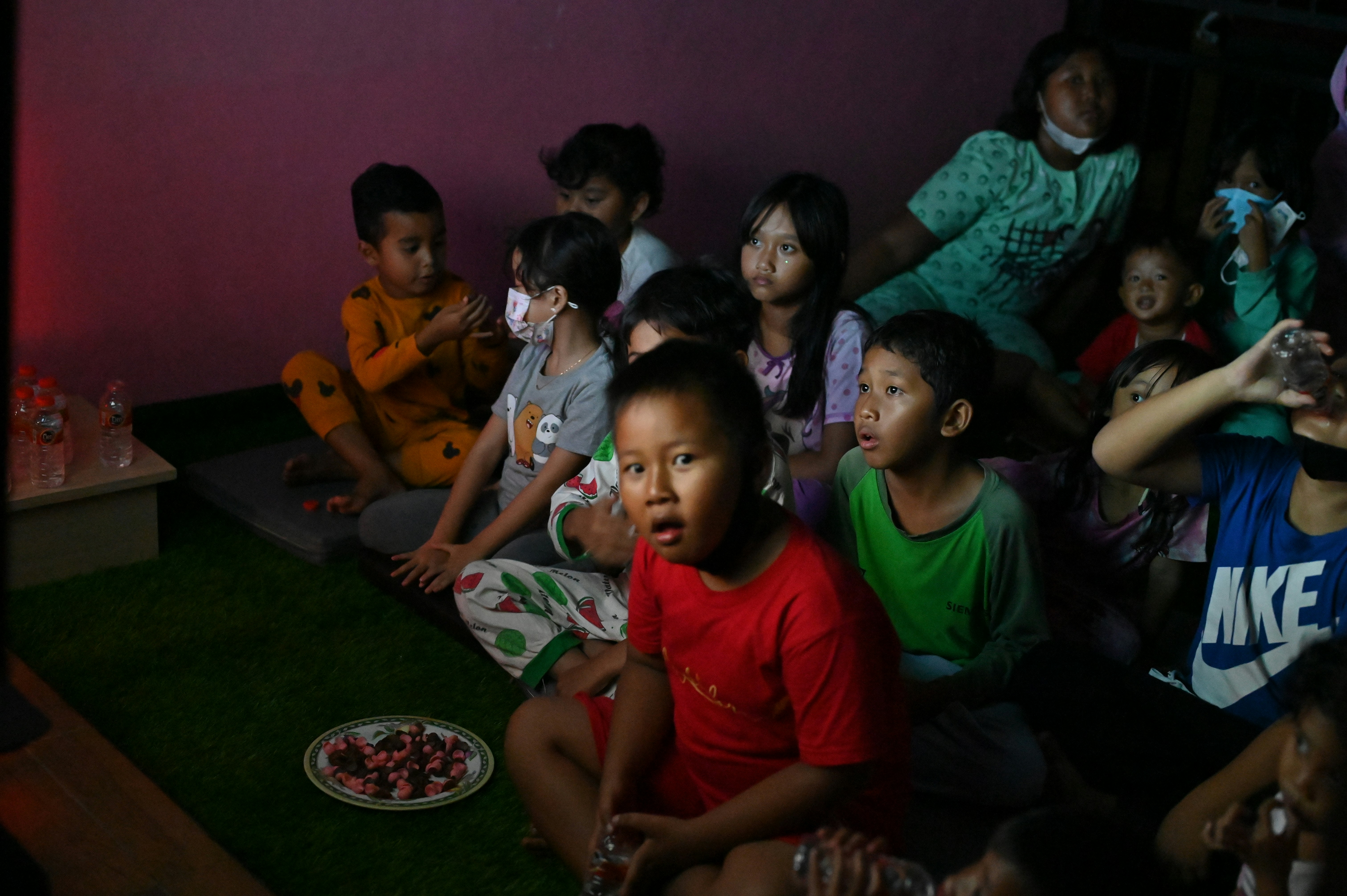 a group of children sitting next to each other