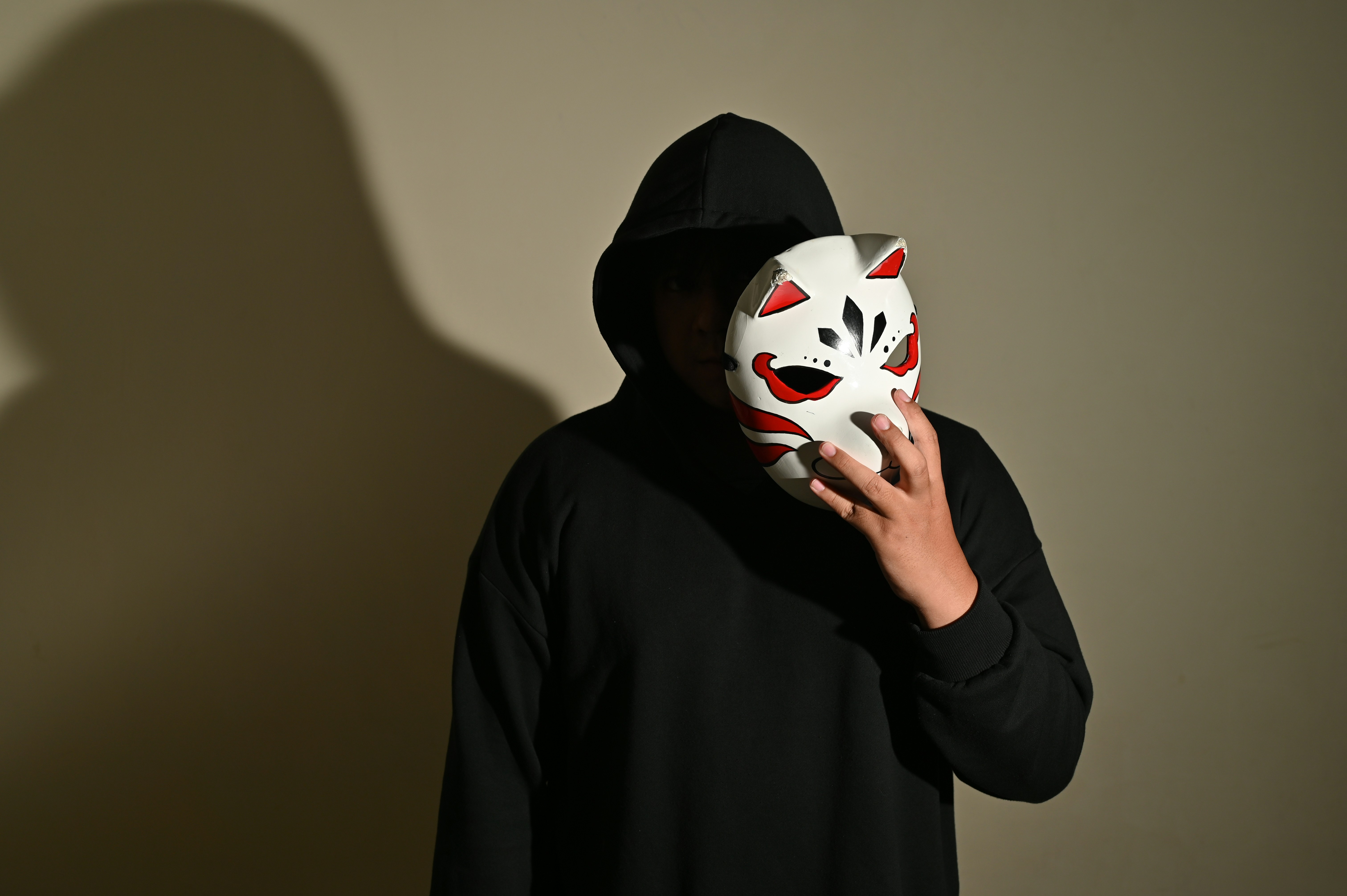 a man with anime shinobi kakashi mask
