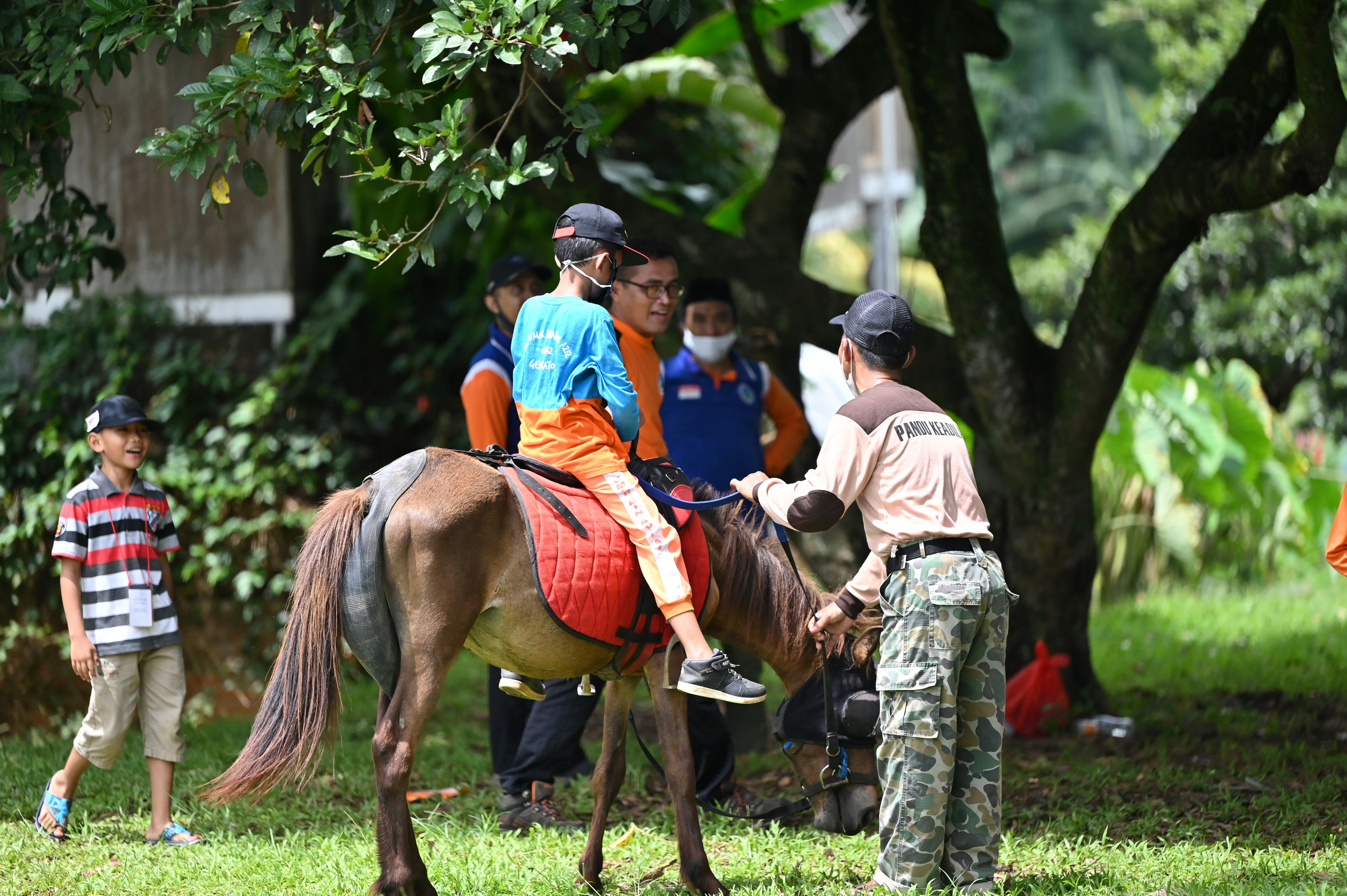 a boy riding a horse