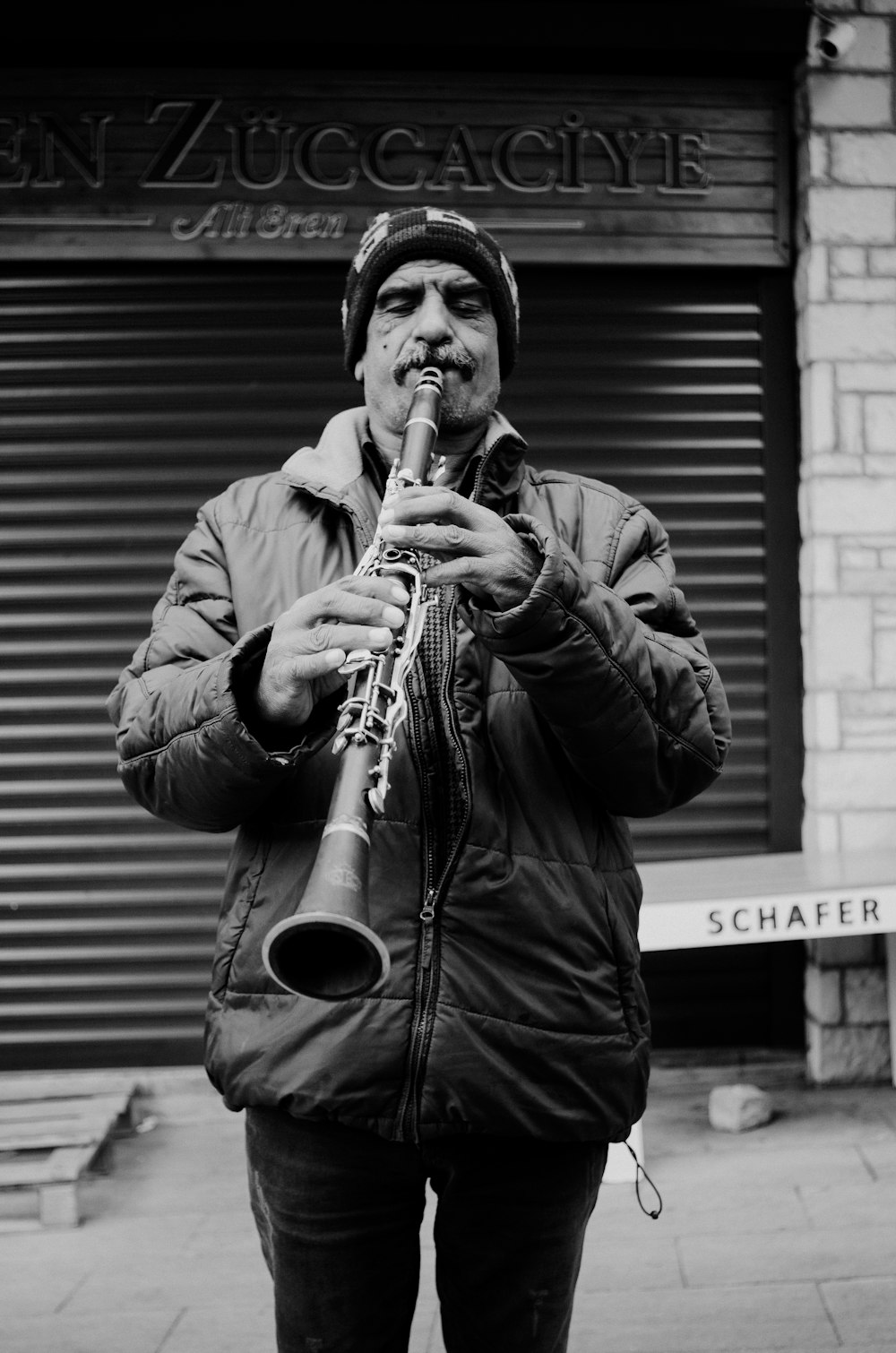 a man playing a trumpet in front of a building