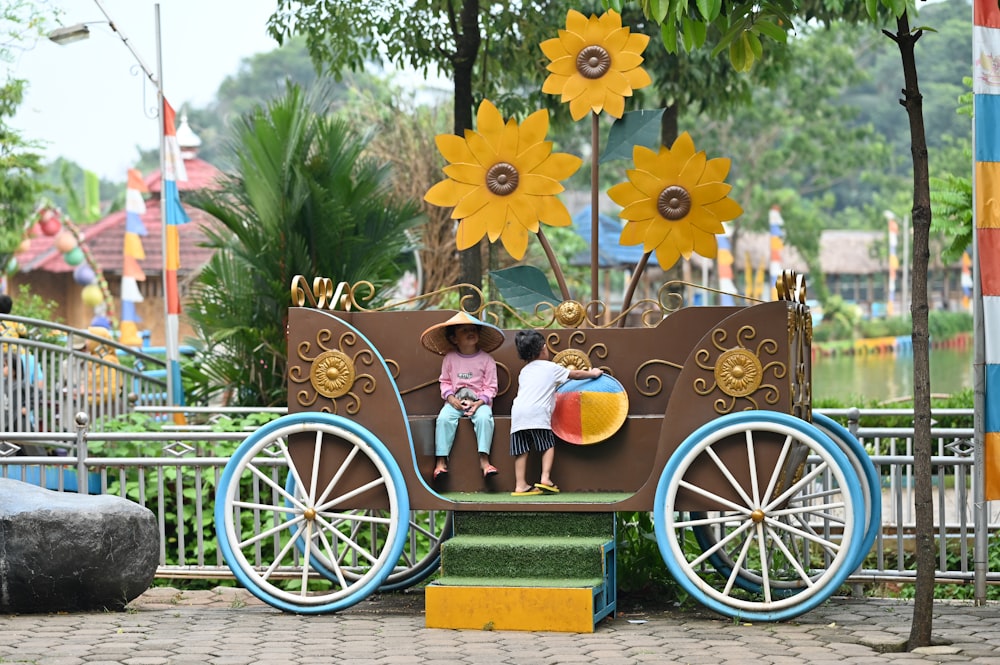 two children are sitting on a horse drawn carriage