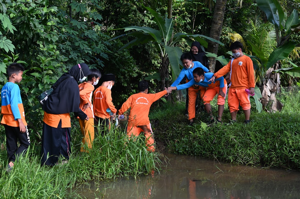 a group of people in orange and blue outfits