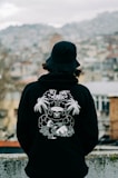 a person wearing a black hoodie with a picture of a gorilla on it