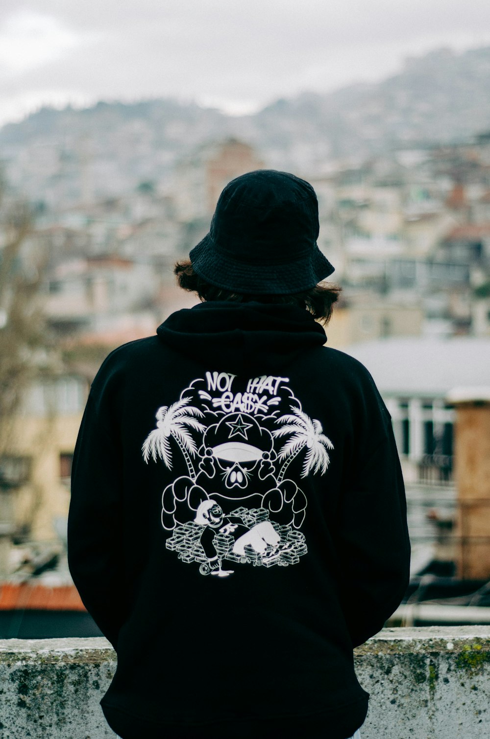 a person wearing a black hoodie with a picture of a gorilla on it
