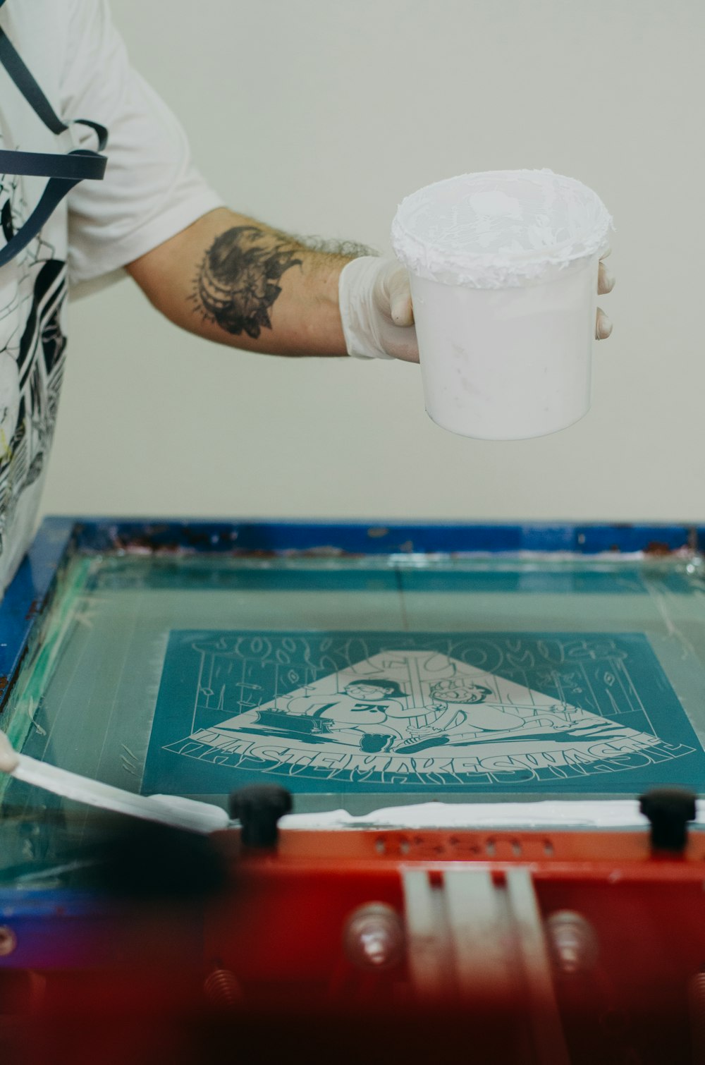 a person holding a cup over a screen