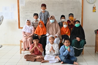a group of children wearing face masks pose for a picture