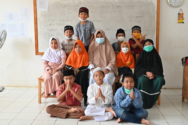 a group of children wearing face masks pose for a picture