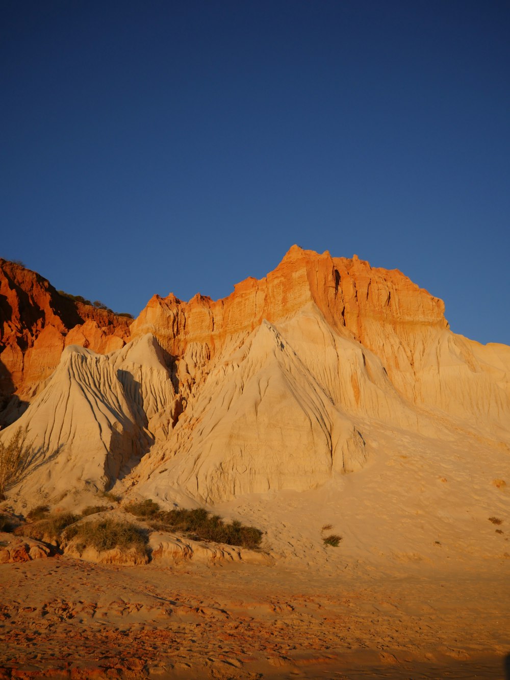 a mountain range with a blue sky in the background