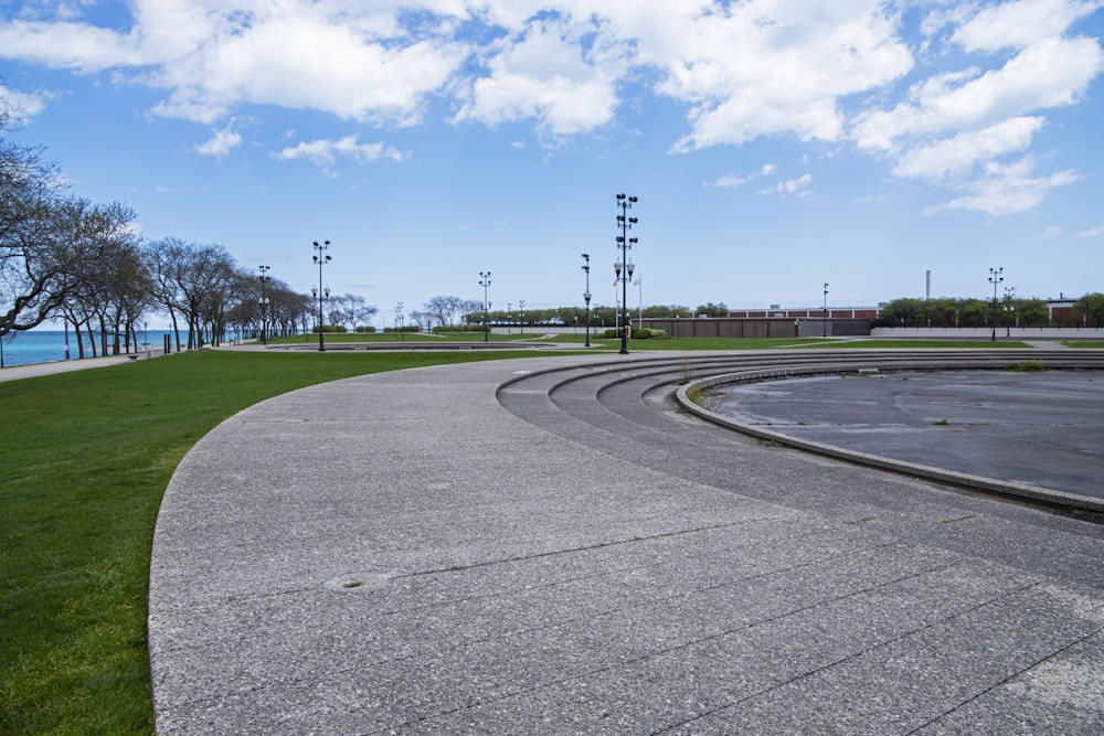 a curved concrete road next to the ocean