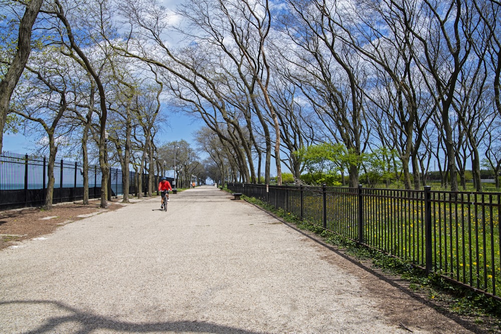 a person riding a bike down a dirt road