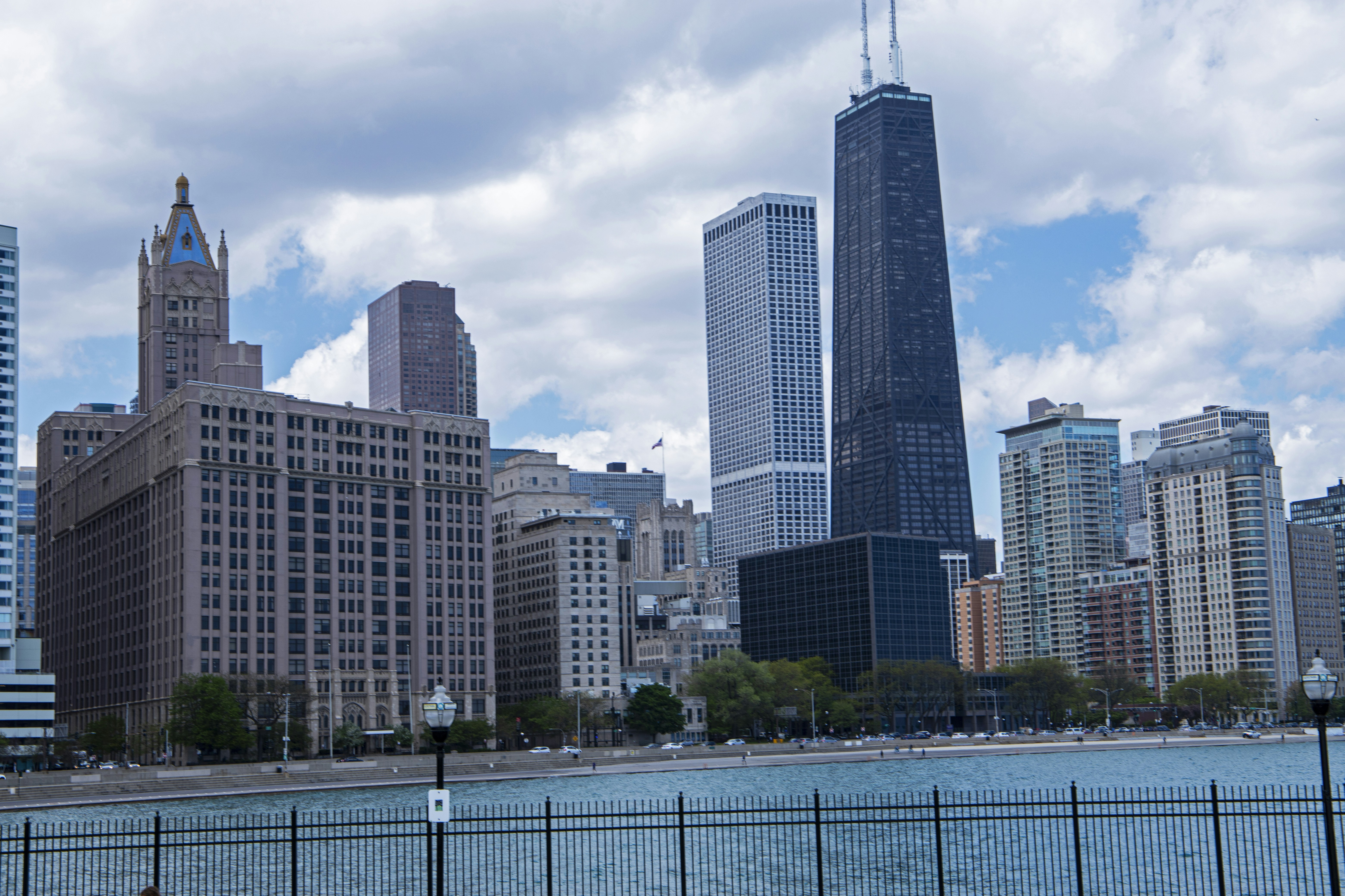 a view of a city with tall buildings next to a body of water, 
