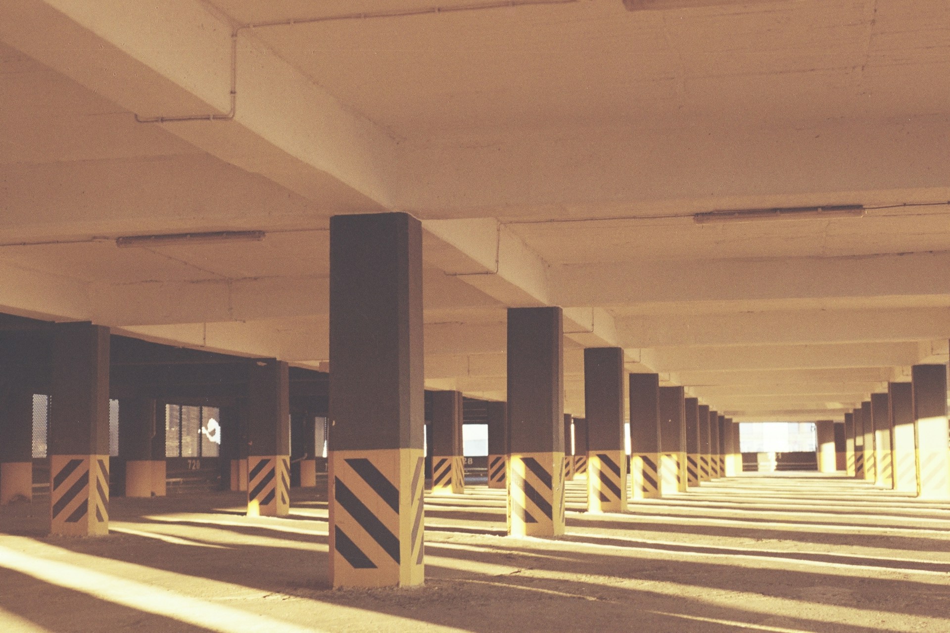an empty parking garage filled with lots of columns