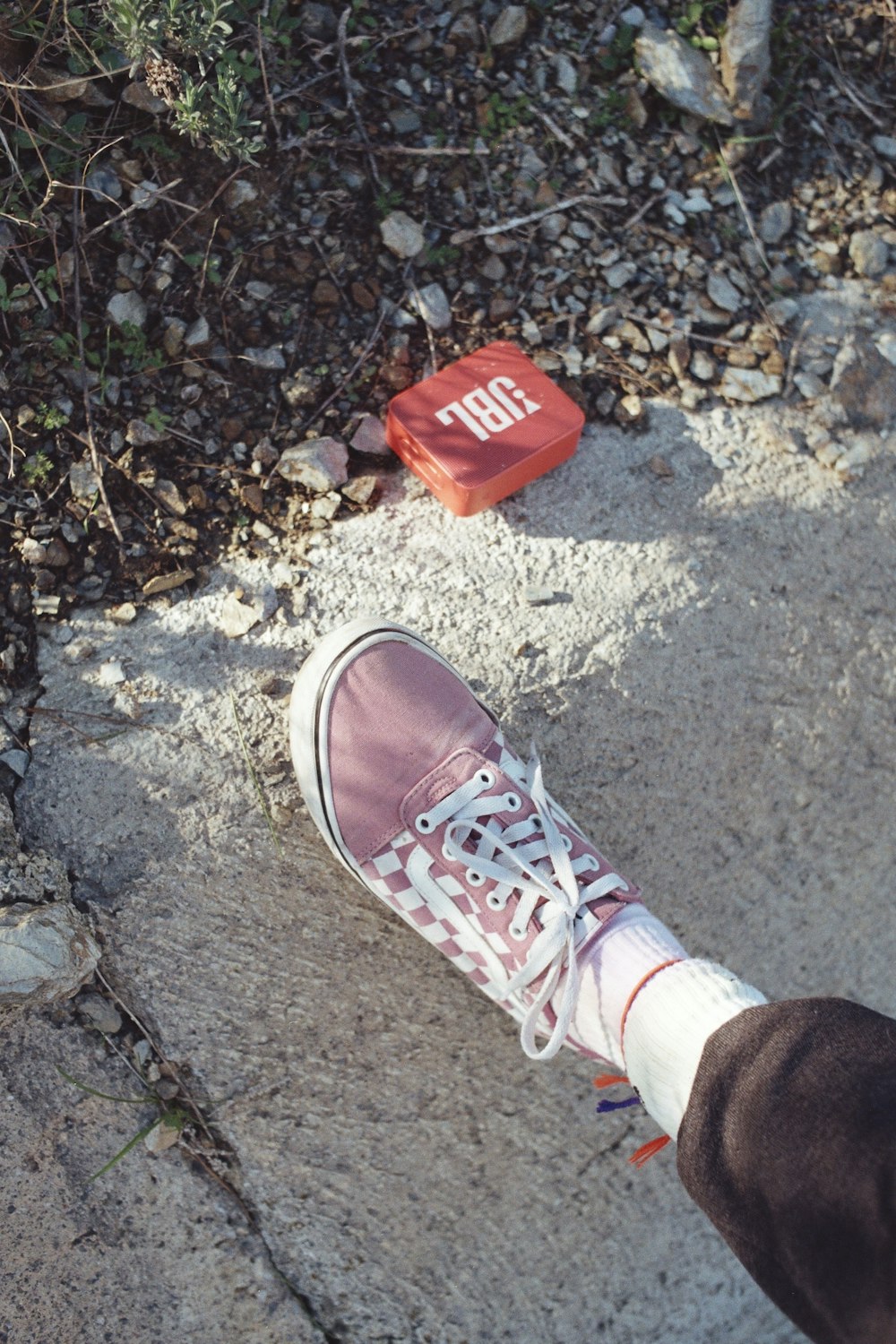 a person standing on a sidewalk next to a frisbee