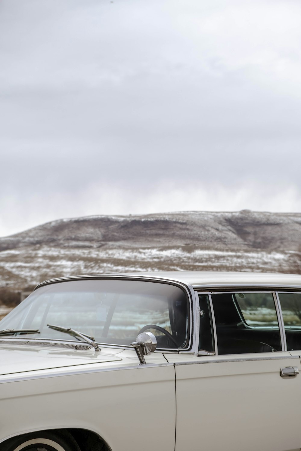 a white car parked on the side of a road