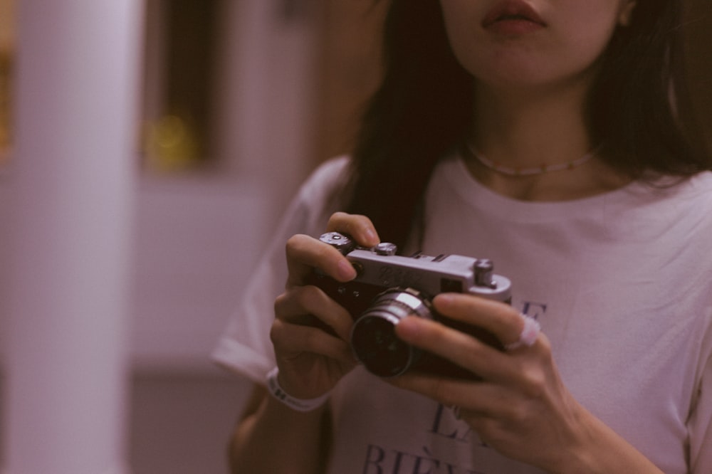 a woman holding a camera in her hands