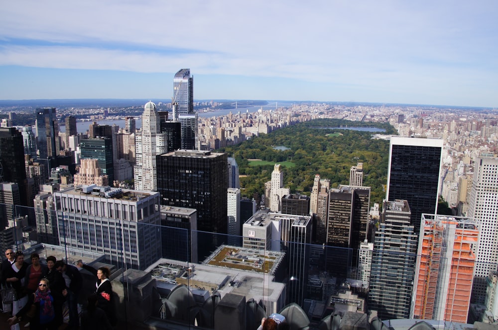 a group of people standing on top of a tall building