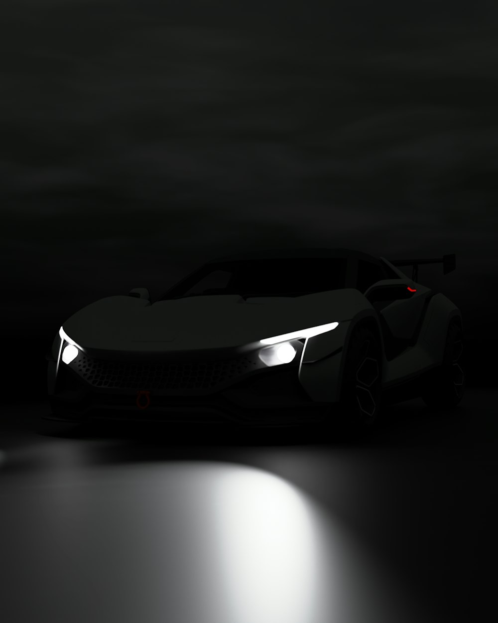 a car is shown in the dark with its headlights on