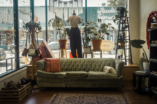 a living room filled with furniture and lots of windows