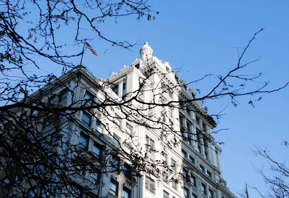 a tall building with a flag on top of it