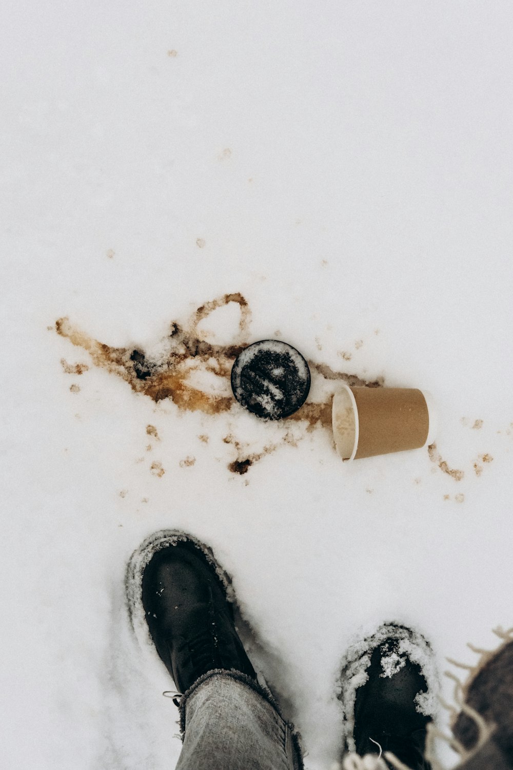 a person standing in the snow with their feet in the snow