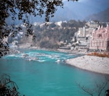 a body of water surrounded by trees and buildings